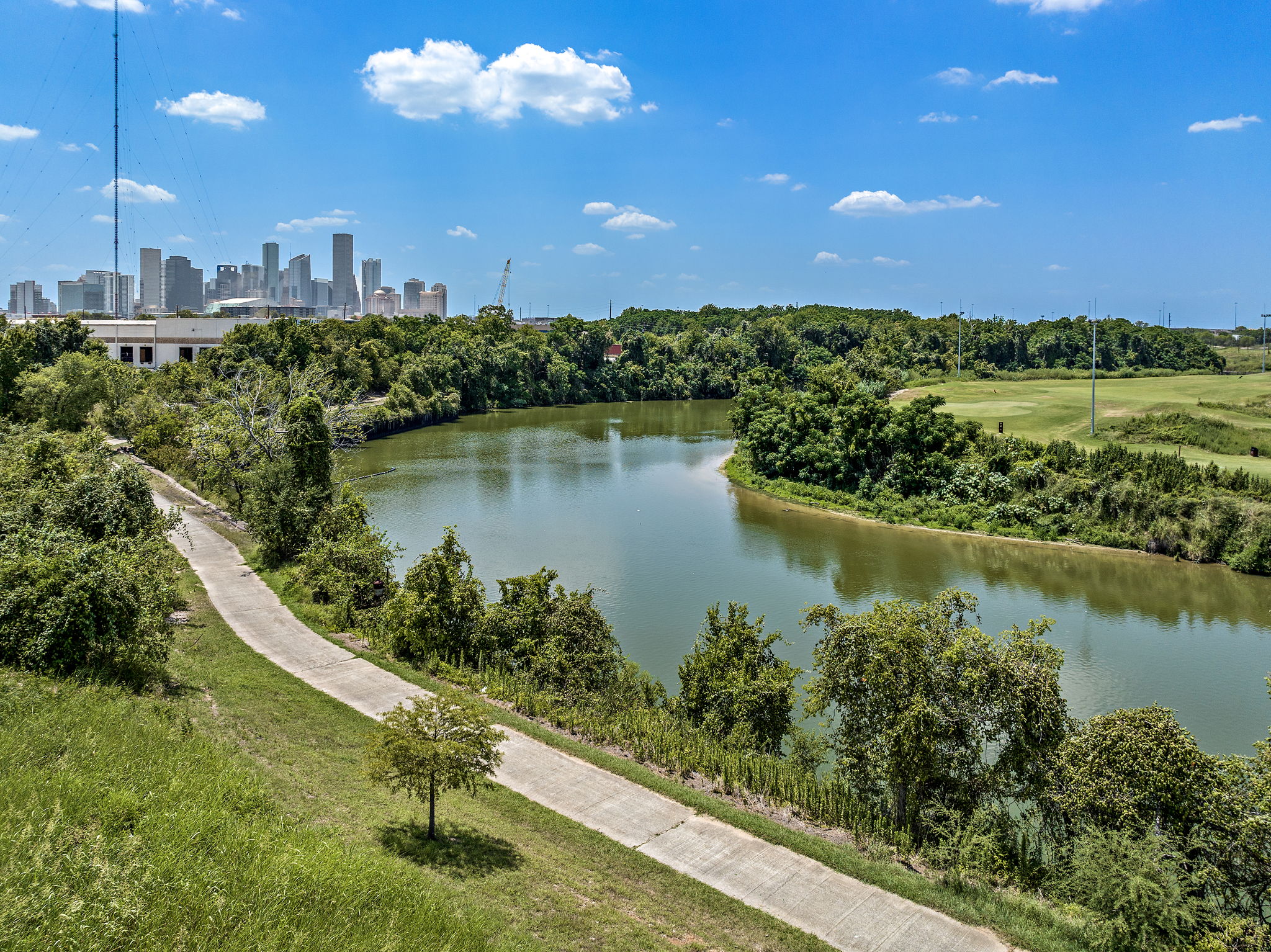 Winding paths in the Buffalo Bayou with a view of East River 9 on the other side