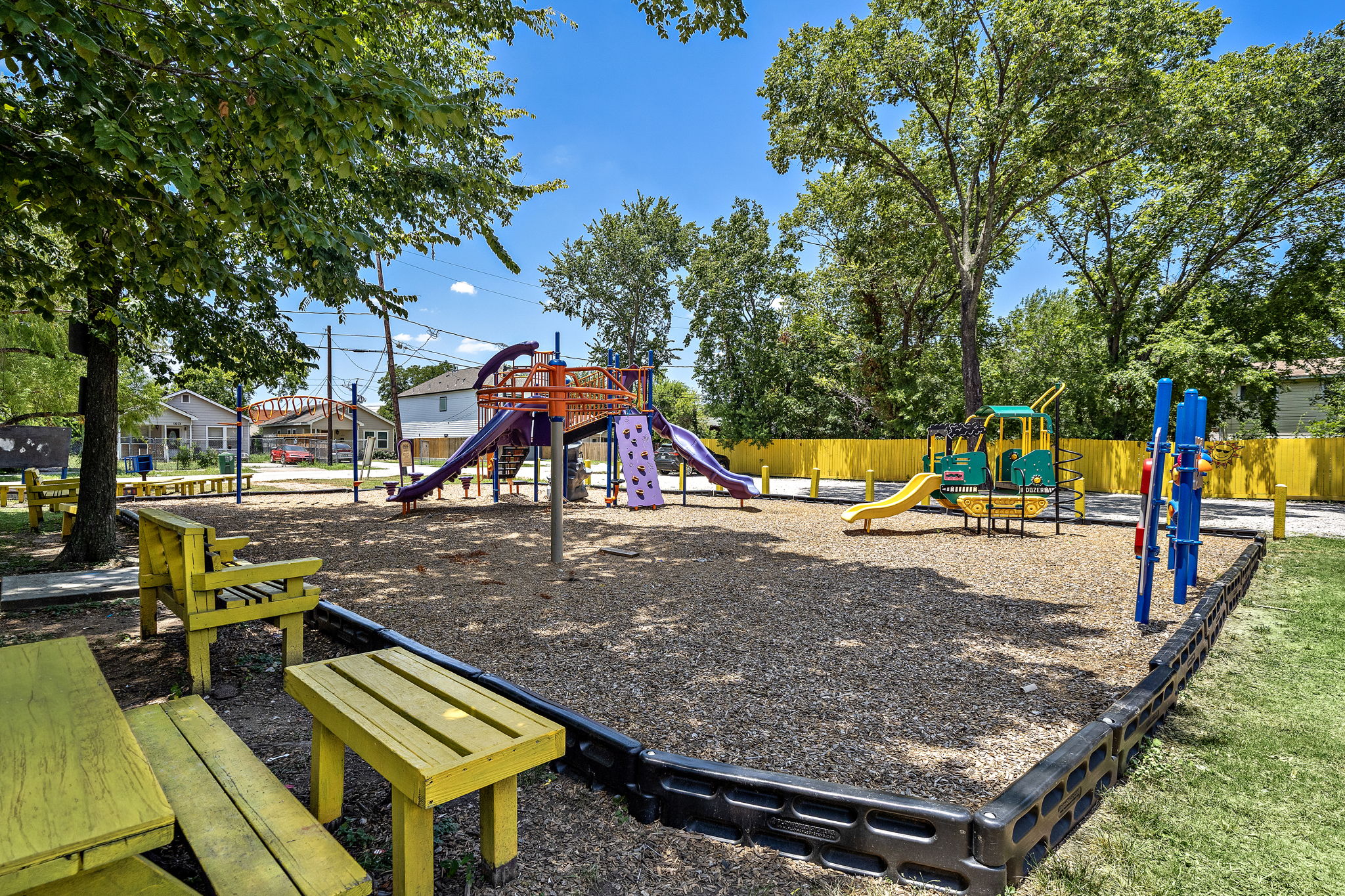 Jam Park playground with slides, monkey bar, and seating areas