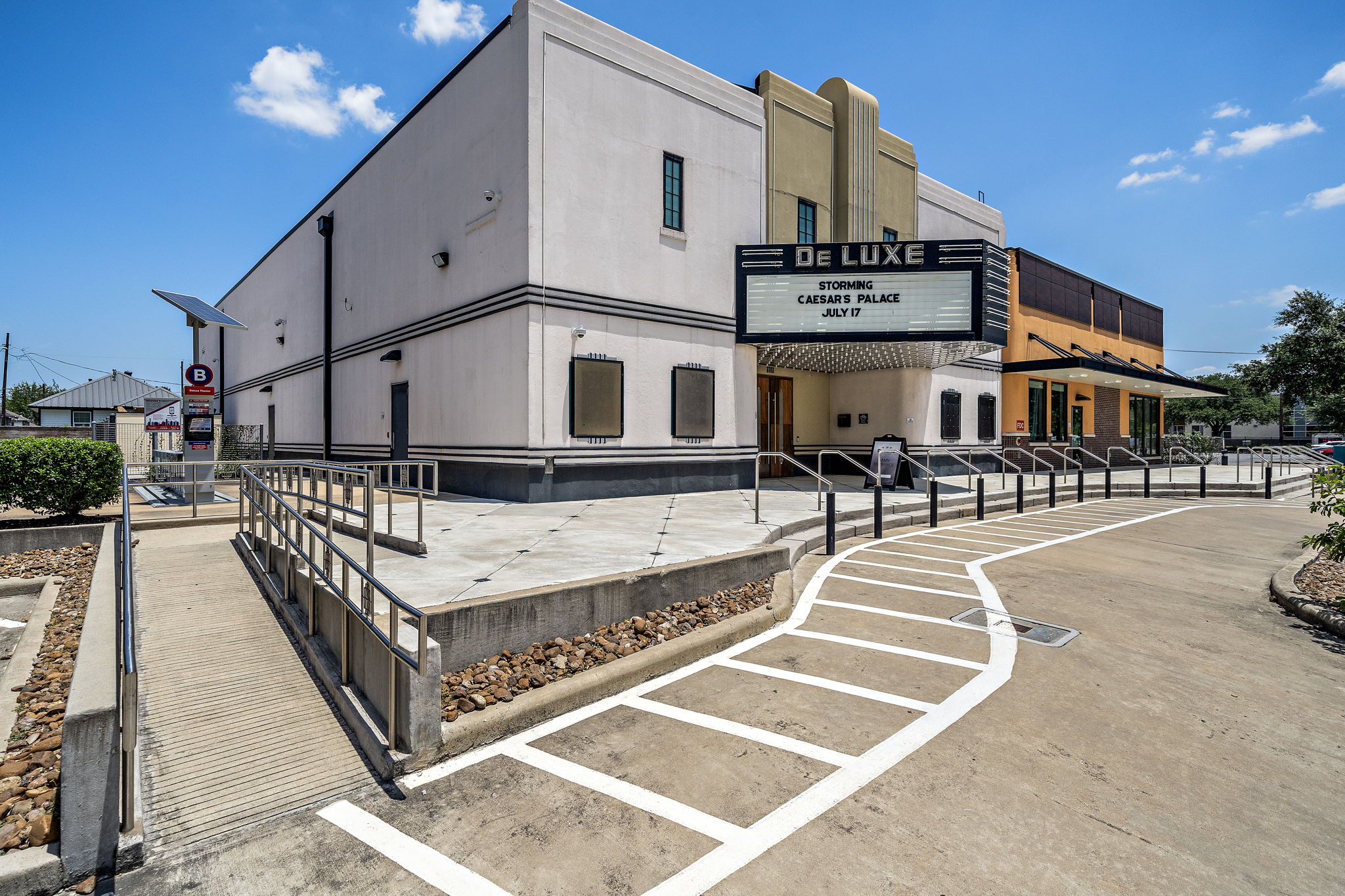 The DeLUXE Theater entrance showing the driveway with access ramp